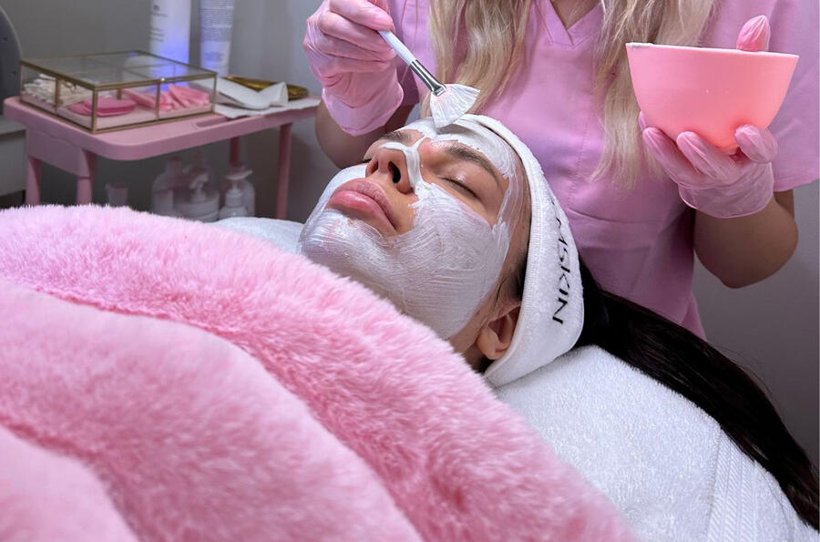 Client enjoying a customized facial mask treatment at Karina Skin Studio